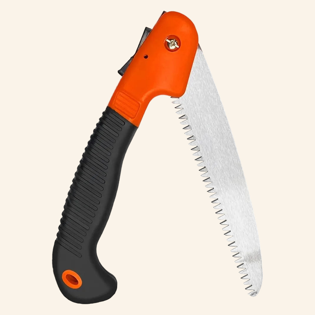 Folding saw with orange and black handle on a white background
