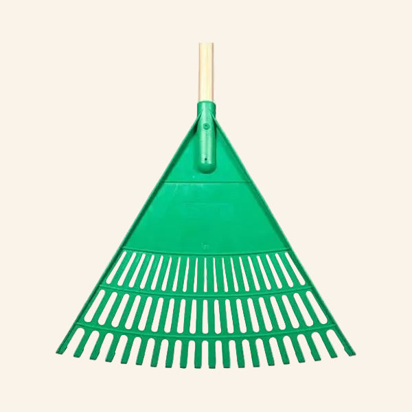 Green garden rake with wooden handle on a white background
